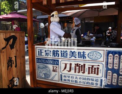 Kunming, Kunming, China. 21st Apr, 2018. Kunming, CHINA-21st April 2018: A 'Pigsy' shaped robot makes sliced noodle at a restaurant in Kunming, south China's Yunnan Province, April 21st, 2018. Credit: SIPA Asia/ZUMA Wire/Alamy Live News Stock Photo