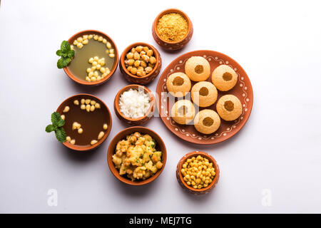Pani Puri is Indian chat item served in a terracotta bowls and plate which is a popular readside snack from India Stock Photo