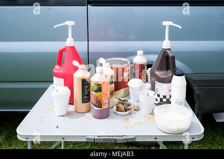 Very British condiments: sauces, used teabags and sugar on a table at a summer horse fair in County Durham England. Stock Photo