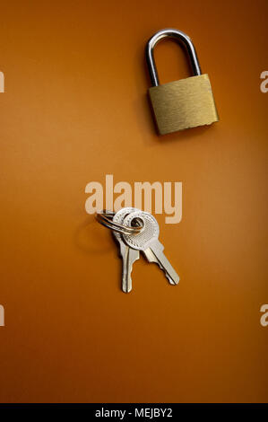 closed padlock and keys lie on a dark background. Stock Photo