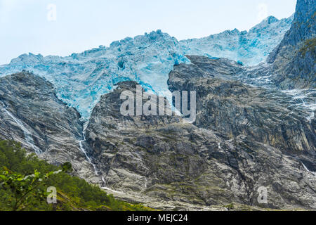 glacier Supphellebreen, close up, part of the Jostedalsbreen National Park, Norway, near Fjaerland, huge blue shimmering ice masses above the rocks Stock Photo