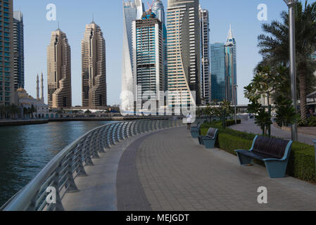 A view of the impressive architecture consisting of tall skyscrapers surrounding Dubai marina with a pretty mosque nestled among them Stock Photo
