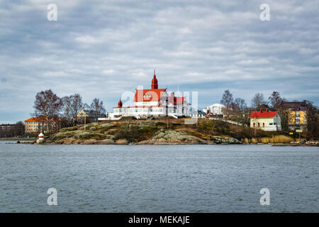 This is Luoto Island in Helsinki harbour, Finland at the begining of Spring. There is an old white building with a bright red roof Stock Photo