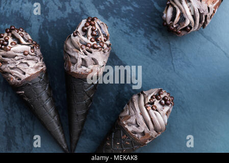 Double Chocolate Ice Creams with Black Waffle Cones on Dark Background Stock Photo