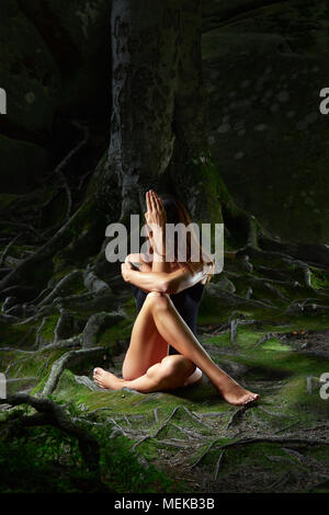 Young woman practicing yoga outdoors Stock Photo
