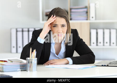 Front view portrait of a worried executive looking at camera at office Stock Photo