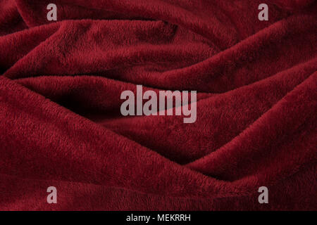 Full-frame burgundy red velvet cloth with curves in the fabric background Stock Photo