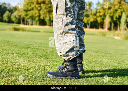 Feet of soldier in military boots. Stock Photo