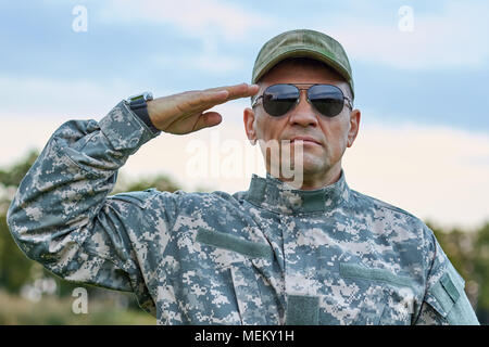 Sergeant in sunglasses saluting portrait. Stock Photo