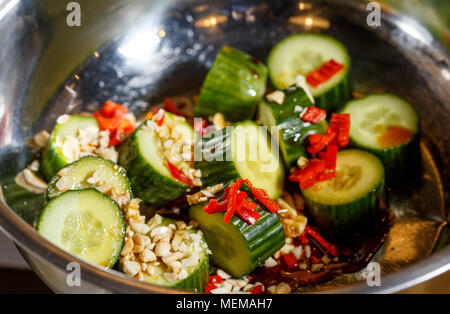 Chinese salad of beaten cucumbers with garlic, chili pepper, soy sauce and sesame oil Stock Photo