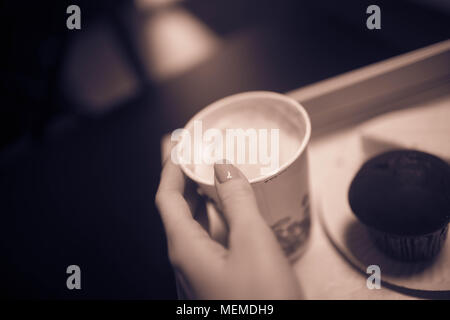 Woman's hand holding a Cup of coffee. Stock Photo