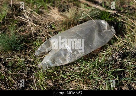 Garbage left in the forest. Plastic bottles littering forest areas and parks. Season of the spring. Stock Photo