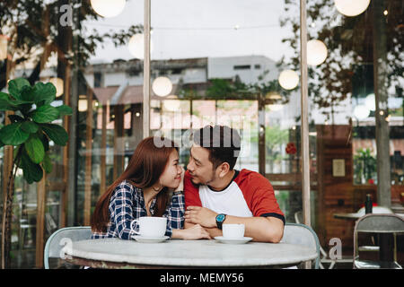 Lovely asian couple having coffee Stock Photo