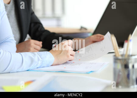 Close up portrait of an office worker hands coworking checking documents on a desktop Stock Photo