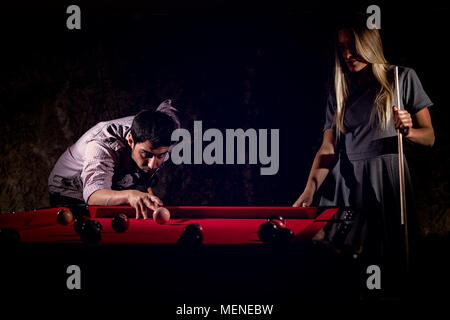 Young romantic couple playing billiard game Stock Photo