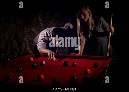 Young romantic couple playing billiard game Stock Photo