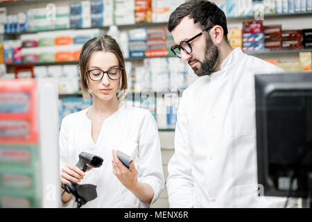 Pharmacists working in the pharmacy store Stock Photo