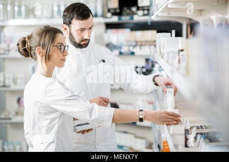 Pharmacists working in the pharmacy store Stock Photo