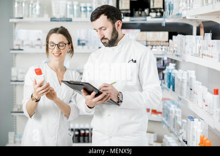 Pharmacists working in the pharmacy store Stock Photo