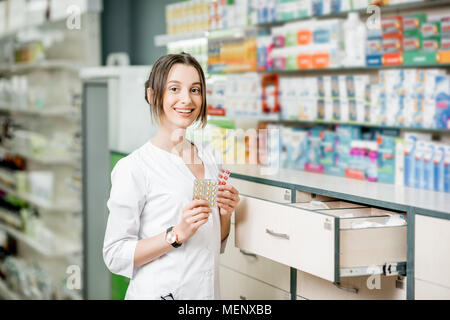 Pharmacist portrait in the pharmacy store Stock Photo