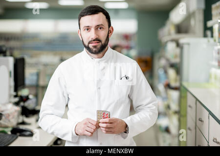 Pharmacist in the pharmacy store Stock Photo