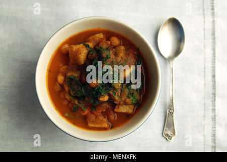 Simple vegetable soup. European cuisine. Chickpeas, potato and carrot. Organic food. Vegan dish. Vegetarian lunch. Top view. Stock Photo