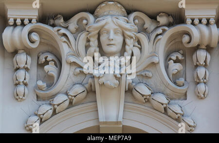 Architectural detail with a mascaron of a young woman set on top of a column on the facade of an old building, Zagreb, Croatia Stock Photo