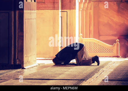 The muslim prayer for god in the mosque. Old iranian Muslim is on his knees praying. Holy month of Ramadan Muslims. Moslem, mohammedan, muslimah. monk Stock Photo