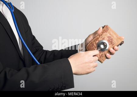 business man using stethoscope for wallet Stock Photo