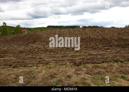 The freshly ploughed earth of a field in spring Stock Photo