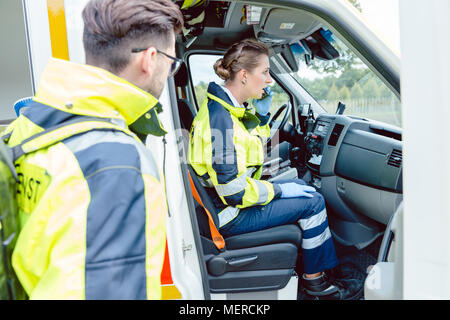 Emergency paramedics helping woman in ambulance bike accident thermal ...