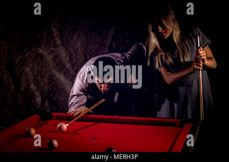 Young romantic couple playing billiard game Stock Photo