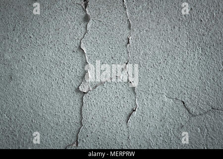 cracked concrete wall covered with gray cement texture as background for design. Stock Photo