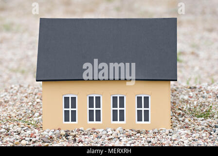 Model of a house on the gravel. Stock Photo