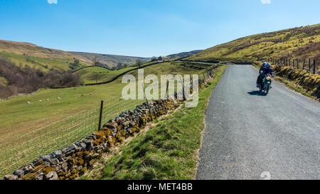 Motorcyclists enjoying empty roads and stunning views in Swaledale on a beautiful sunny day, B6270, Yorkshire Dales Stock Photo