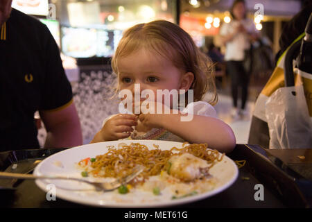 15 month old eating noodles Stock Photo