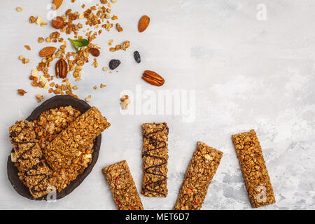 Granola bars and ingredients. Healthy sweet dessert snack. Vegan granola bar with nuts, chocolate  and berries on a white background. Top view, copy s Stock Photo