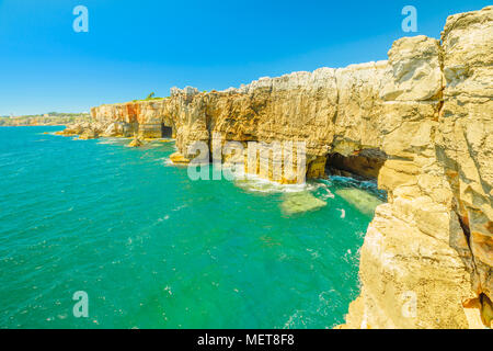 Scenic landscape of Boca do Inferno an open cavern in the coast of Cascais, Portugal. Hell's Mouth is a rough cliff formation with a natural arch and touristic sightseeing spot on Atlantic Coast. Stock Photo