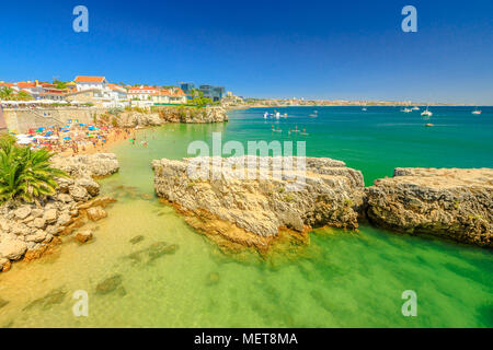 Scenic landscape of Praia da Rainha, small beach with cliffs in Cascais center, Portugal. Aerial view of Lisbon Coast. People sunbathing and swimming in turquoise sea during summer holidays.Copy space Stock Photo