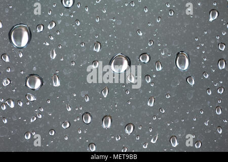 Closeup view of raindrops on a window during rain storm Stock Photo