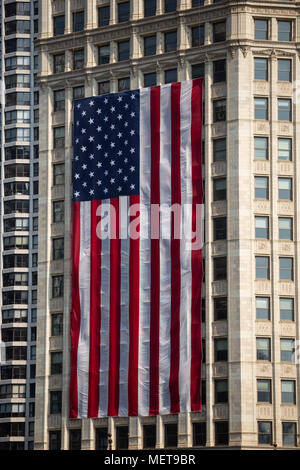 Large United States flag on side of Wrigley Building in downtown Chicago on fourth of July - Chicago, IL Stock Photo