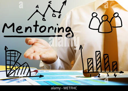 Mentoring concept. Mentor at the table in the office. Stock Photo