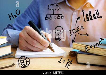 Education concept. Man writing in the notepad. Stock Photo