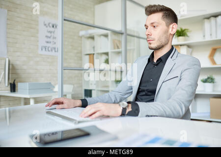 Young Manager Wrapped up in Work Stock Photo