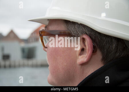 Business construction man engineer architect on the work site overlooking project at waterfront site Stock Photo
