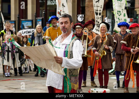 Chester, UK. 23rd April 2018. The compere Russell Kirk performs in the St George's Day parade through Chester city centre. The parade includes street performance, theatre and music with local school children performing many supporting roles. Credit: Andrew Paterson/Alamy Live News Stock Photo