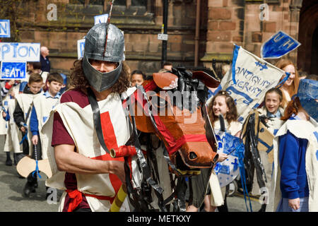 Chester, UK. 23rd April 2018. Phil Cross playing St George performs in the St George's Day parade through Chester city centre. The parade includes street performance, theatre and music with local school children performing many supporting roles. Credit: Andrew Paterson/Alamy Live News Stock Photo
