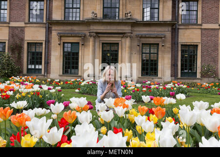 Eltham, United Kingdom. 23rd April, 2018. Elizabeth Cooper from London pictured enjoying the Tulip Festival at Eltham Palace. 40,000 tulips have been planted for the festival which lasts until mid May. Eltham Palace, managed by English Heritage, was a favourite palace of King Henry IV and it is where Henry VIII spent much of his childhood. Rob Powell/Alamy Live News Stock Photo