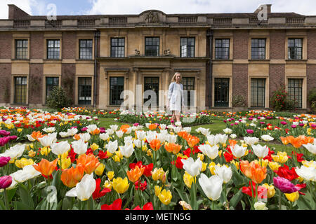 Eltham, United Kingdom. 23rd April, 2018. Elizabeth Cooper from London pictured enjoying the Tulip Festival at Eltham Palace. 40,000 tulips have been planted for the festival which lasts until mid May. Eltham Palace, managed by English Heritage, was a favourite palace of King Henry IV and it is where Henry VIII spent much of his childhood. Rob Powell/Alamy Live News Stock Photo