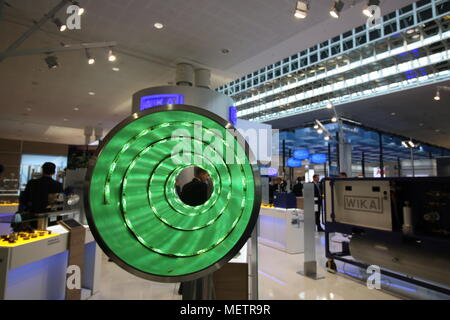 Hannover, Germany - April 23, 2018: Many metal parts are exhibited at the world's largest industrial fair, the Hannover Fair. Here you can see an illuminated tube with measuring devices. Stock Photo